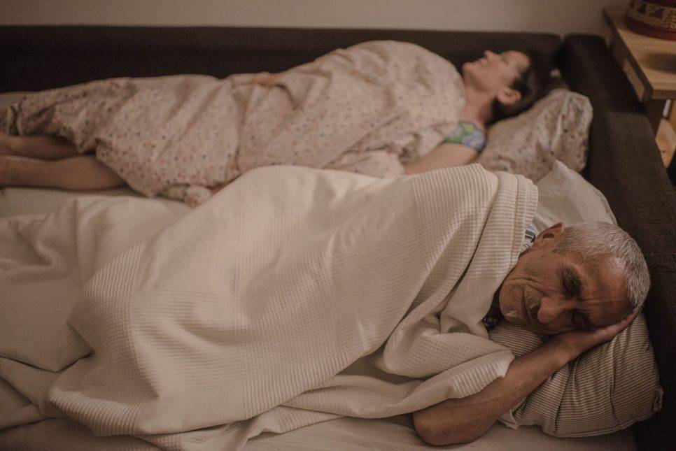 Pasha's parents - Alexander and Tamara sleeping on a sofa in the kitchen of their small Warsaw rental apartment. Photo: Pasha Kritchko