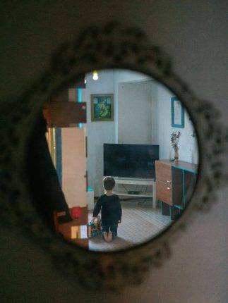 Jenya staring at the TV on one of the visits to his grandparents. Photo: Katerina Shosheva