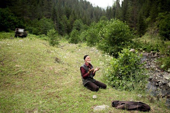 Man praying in the field. Photo: Natela Grigalashvili