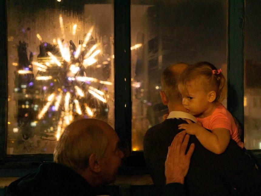 Katerina's father reassuring her niece Evy while watching fireworks on New Year's Eve. Photo: Katerina Shosheva
