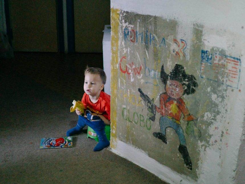 Jenya sitting on a potty and eating a banana next to the drawing made by my brother back in the late 80s when our parents got the apartment. Photo: Katerina Shosheva