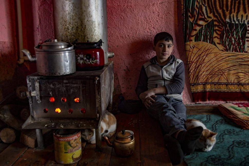 After doing his homework, Shindan helps his father in household chores and gardening work, and then has a rest during the day. Photo: Orkhan Azimov